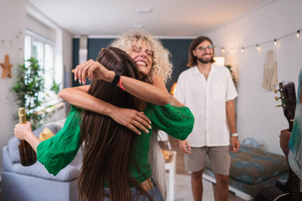 istock Female house party host, greeting her fiends who just arrived 1596033535