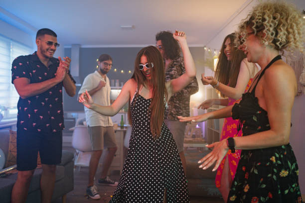 istock Caucasian friends dancing during an house party 1596055977