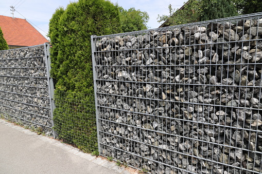 a gabion as a privacy screen with plants in between
