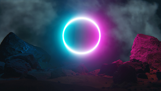 Neon lit time machine or portal to an unknown world. Colorful circle above the ground covered with rocks and cliffs.