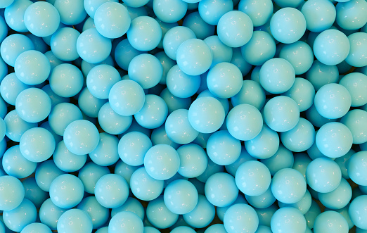 Blue balls lay in a heap. Abstract background. The balls shine.