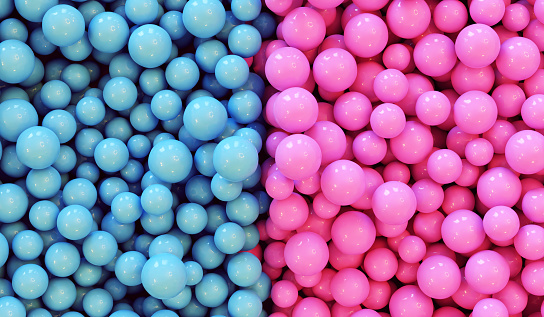 Abstract background with colorful balls in a heap. The balls has the colors pink and light blue. Stereo type symbols for male and female, boy and girl. Concept of mixing or separating the colors and genders.