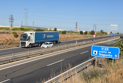 Semi truck by JUAN JOSE GIL with Semi-trailer driving along highway. Goods Delivery by roads. Services and Transport logistics. Import - Export. April 12, 2023, Spain, Port Sagunto.