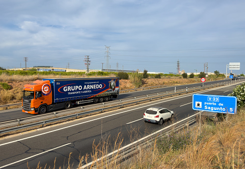 Semi truck by Arnedo Logistics Group with Semi-trailer driving along highway. Goods Delivery by roads. Services and Transport logistics. Import - Export. April 12, 2023, Spain, Port Sagunto.