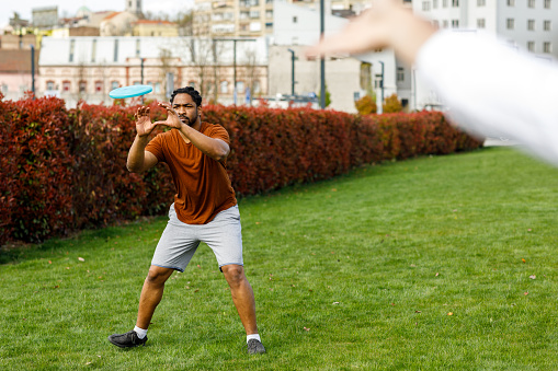 Young African is Enjoying in Summer Day and Trying to Catch a Frisbee.