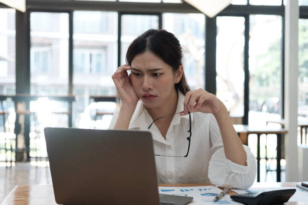 istock Upset and stressful young businesswoman feeling tired while working on her project, overworked businesswoman. 1596148807