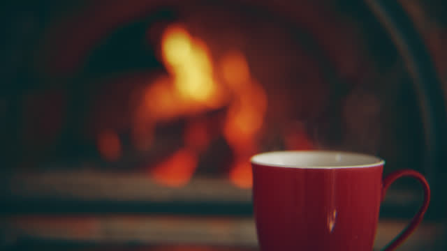 DS A cup of tea with a background of a fireplace