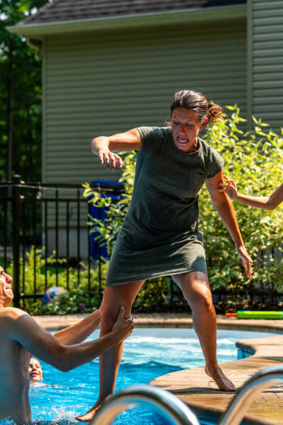 istock Family having fun around a pool. 1596172546