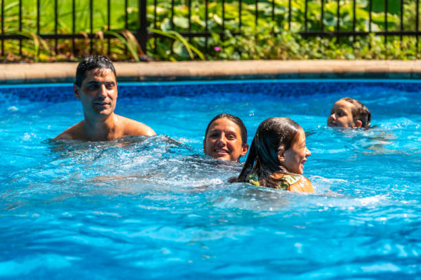 istock Family having fun in a pool. 1596174080