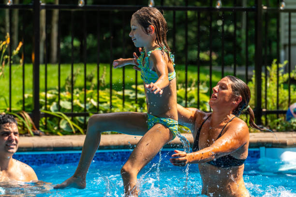 istock Family having fun in a pool. 1596175144