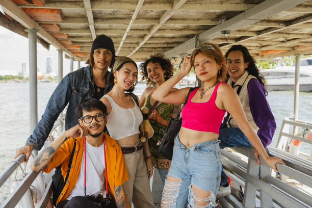 Portrait of a group of Friends having special memories together while traveling by ferryboat to explore Bangkok on holiday.