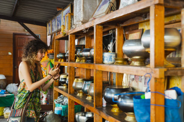 Asian woman learning to make alms bowls from a local artisan in the community.