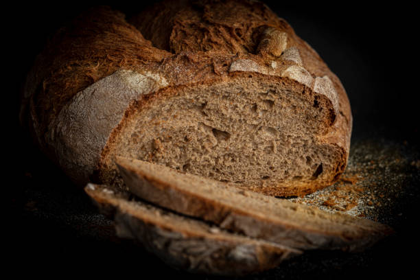 istock fermented bread traditional bread made with sliced sourdough on a black background. Concept of traditional rustic bread baked with natural ferments in a wood-fired oven 1596203481
