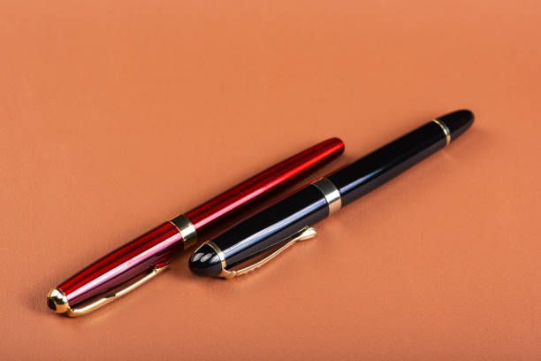 istock Fountain pens, beautiful fountain pens placed on brown leather surface, selective focus. 1596213636