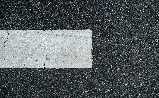 Road marking on asphalt close-up