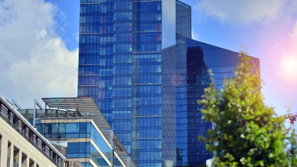 istock Reflection of modern commercial building on glass with sunlight. Eco architeectur 1596244698