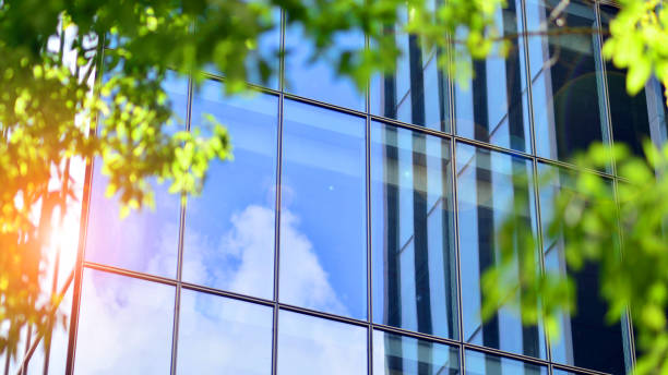 istock Reflection of modern commercial building on glass with sunlight. Eco architeectur 1596245224