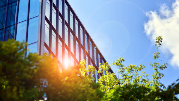 istock Reflection of modern commercial building on glass with sunlight. Eco architeectur 1596245736