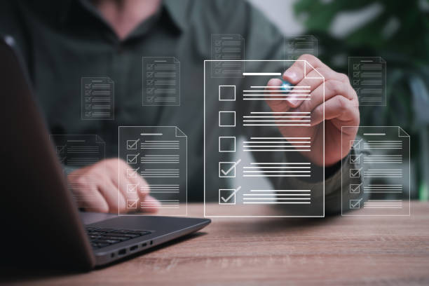 istock Smart checklist Businessman document management concept, Businessman takes an assessment checks on digital checklist and uses a laptop to manage documents online in a storage system with paperless 1596258248