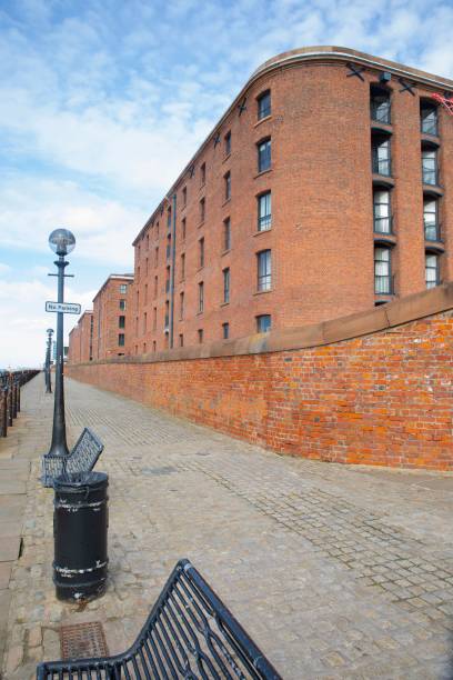 istock there is a brick wall that separates a building and has two benches on it 1596287346