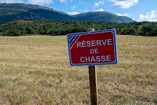 Saint-Pierre-d'Argençon, France - August 8, 2023: Sign written in French indicating a hunting reserve, an area in which it is forbidden to hunt in order to allow the renewal of game populations