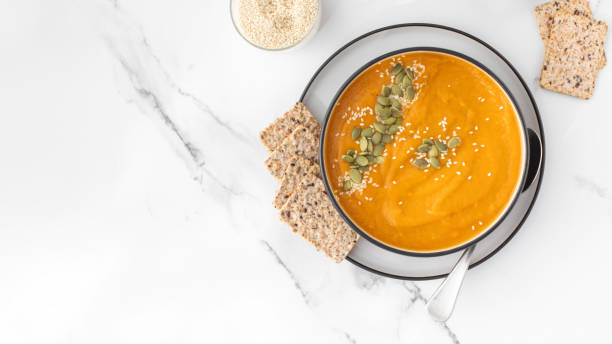 istock A bowl of pumpkin soup with mashed potatoes and seeds. Autumn menu. Copy space 1596305633