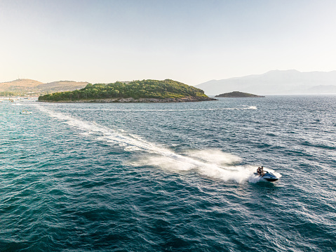 Aerial view of jet skier racing through waves in the adriatic sea. Water racing on jet-skis.