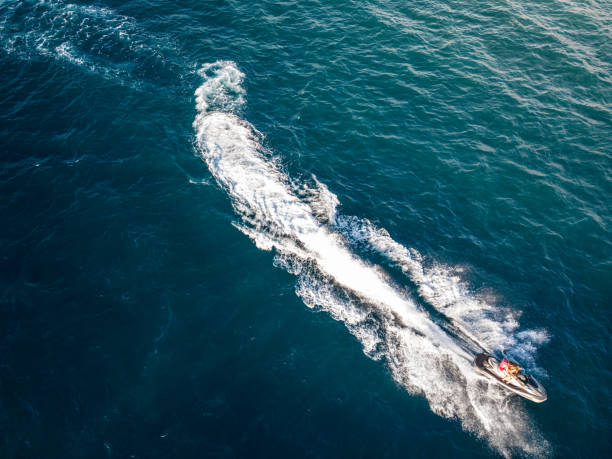istock Jet skier racing through waves on rough waters 1596308397