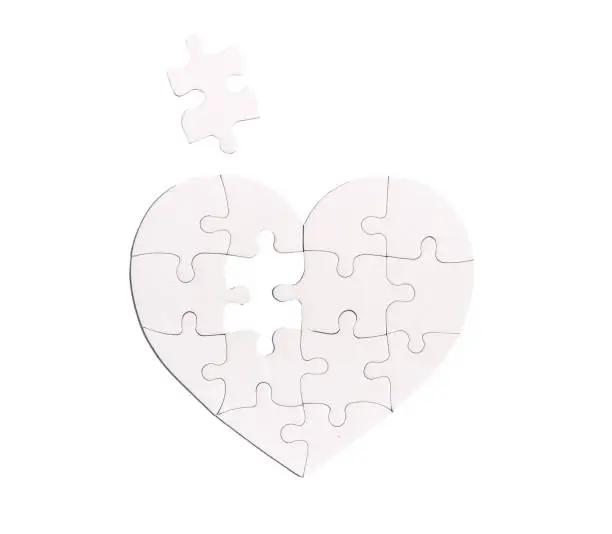 Photo of Heart shaped puzzle with missing lacking piece isolated on white background. Love problems concept