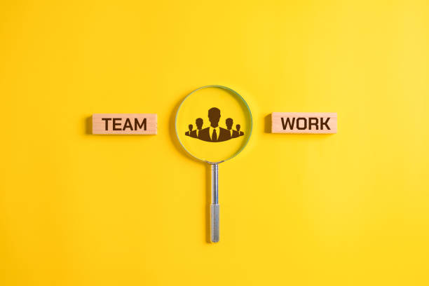istock Teamwork word on wooden blocks with magnifying glass, Business and teamwork concept, Unity of company, Business corporation 1596323804