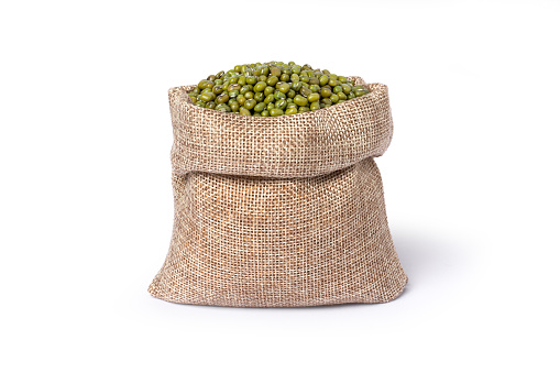 Green mung bean in hemp sack bag isolated on white background.