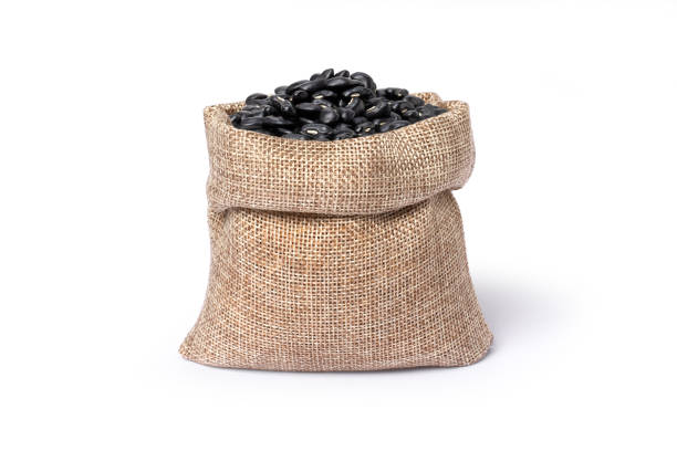 istock Black beans (Urad dal, black gram, vigna mungo) in hemp sack bag isolated on white 1596328013