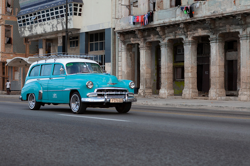 havana, cuba - march 12, 2019: classic car driving through havana city in cuba.