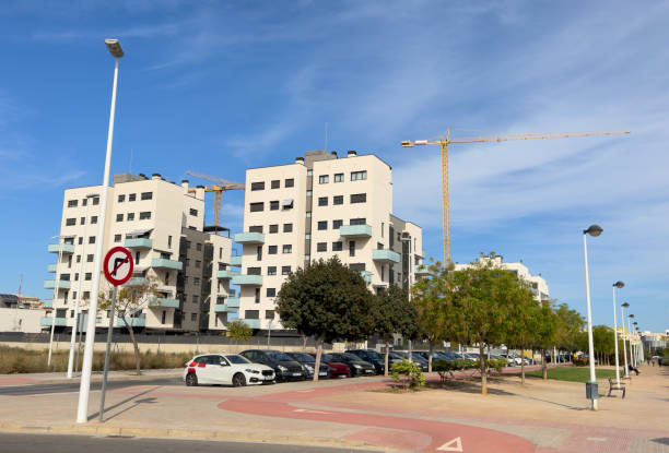 istock Tower crane on construction site. Towhouse under construction. Building onstruction at Mediterranean sea. Construction of modern house on coastline, Spain, Sagunto. 1596337769