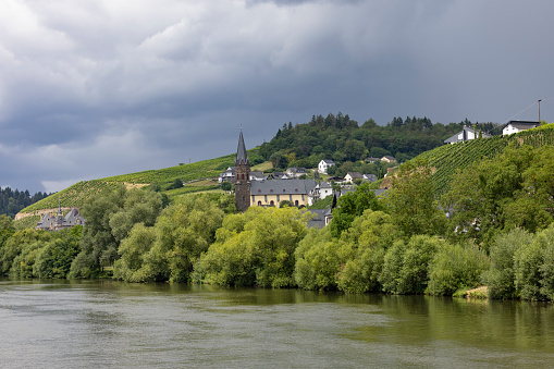 old church in small town at mosel river in germany.