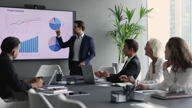 Serious businessman presenting statistic report to work group