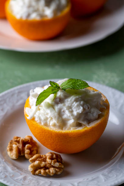 istock Celery salad with apple and walnuts served in orange cups. 1596387166
