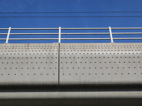 Full frame abstract of the underside of a concrete motorway bridge.