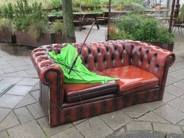 Several pink abandoned sofas under the city viaduct