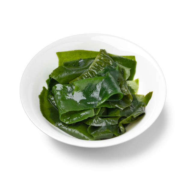 istock Bowl with soaked wakame close up on white background 1596404765