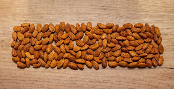 raw almonds on a wooden table