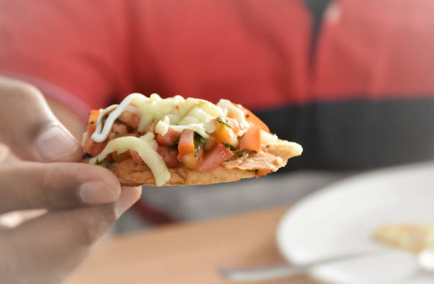 istock A Man holding a Mexican dish called Taco with lots of vegetables stuffed inside 1596420308
