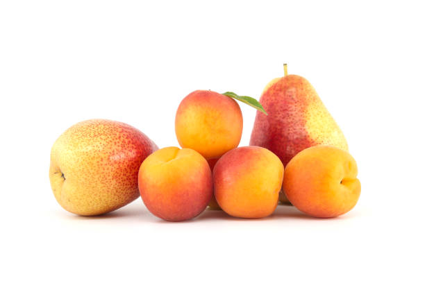 Apricots and multi-colored pear isolated on white stock photo