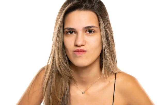 istock Head shot of a young doubtful woman on a white studio background 1596435509