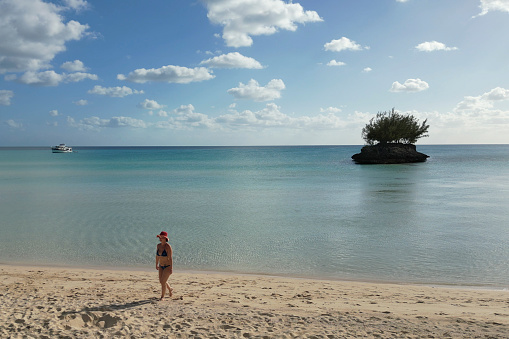 Woman relaxes in shallows below, Eleuthera