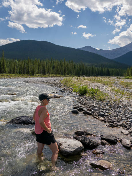 istock Woman relaxes by creekside 1596568206