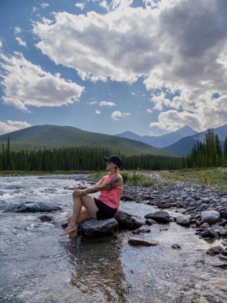 istock Woman relaxes by creekside 1596568208