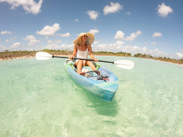 istock Woman canoeing on tropical lagoon in Mexico 1596606256