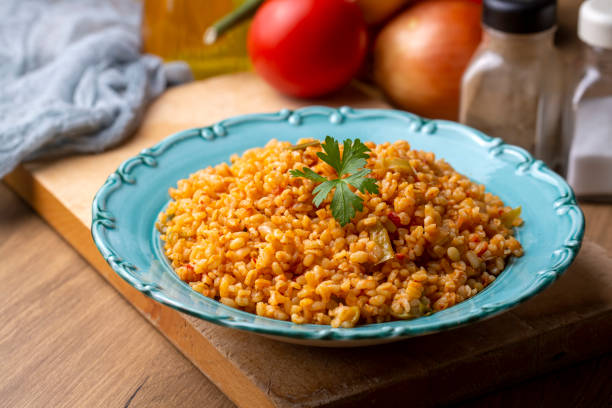 istock Traditional turkish bulgur pilaf with tomato sause in plate (Turkish name; meyhane pilavi) 1596623270
