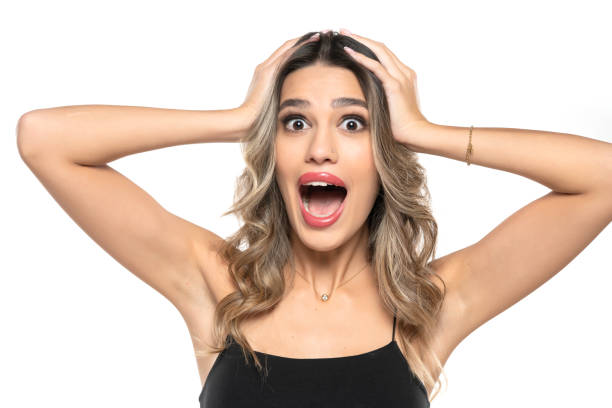 beautiful young surprised happy women with makeup and long wavy hair on a white background. beautiful young surprised happy women with makeup and long wavy hair on a white studio background. teenage girl before and after make up stock pictures, royalty-free photos & images